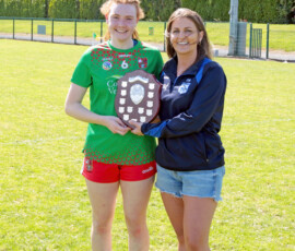 WLGFA committee member Carol Gaffney presents the Div 2 shield to St Annes captain Niamh McGrath